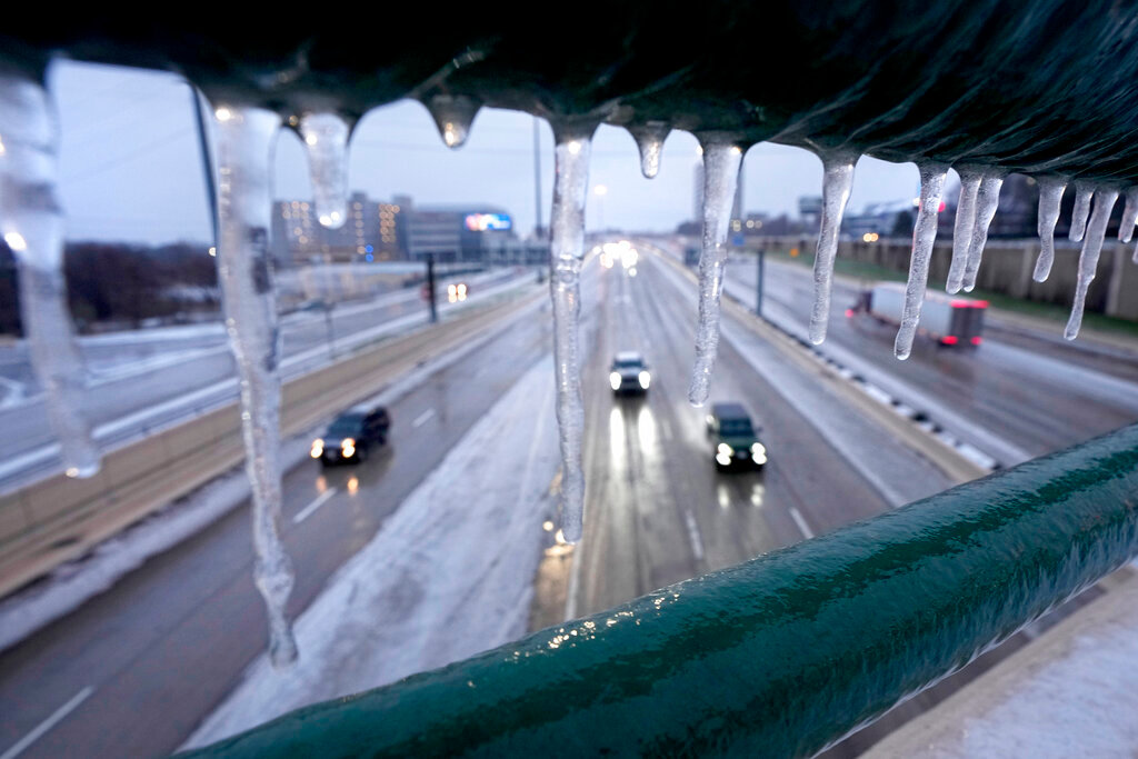 Icicles form on an overhead pass railing as drivers make their way north on US 75, Wednesday, Feb. 1, 2023, in Dallas. (AP Photo/Tony Gutierrez)