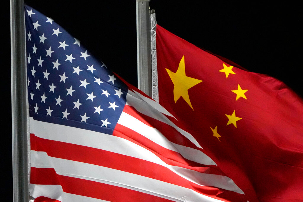 The American and Chinese flags wave at the 2022 Winter Olympics. (AP Photo/Kiichiro Sato, File)