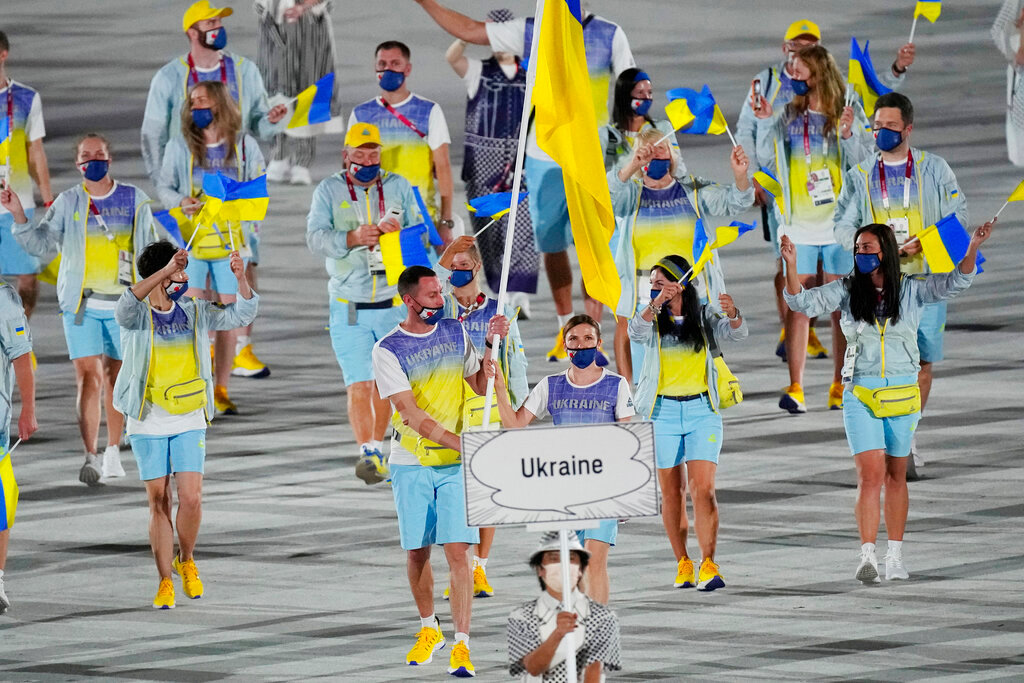 Olena Kostevych and Bogdan Nikishin, of Ukraine, carry their country's flag during the opening ceremony in the Olympic Stadium at the 2020 Summer Olympics, on July 23, 2021, in Tokyo, Japan. (AP Photo/David J. Phillip, File)
