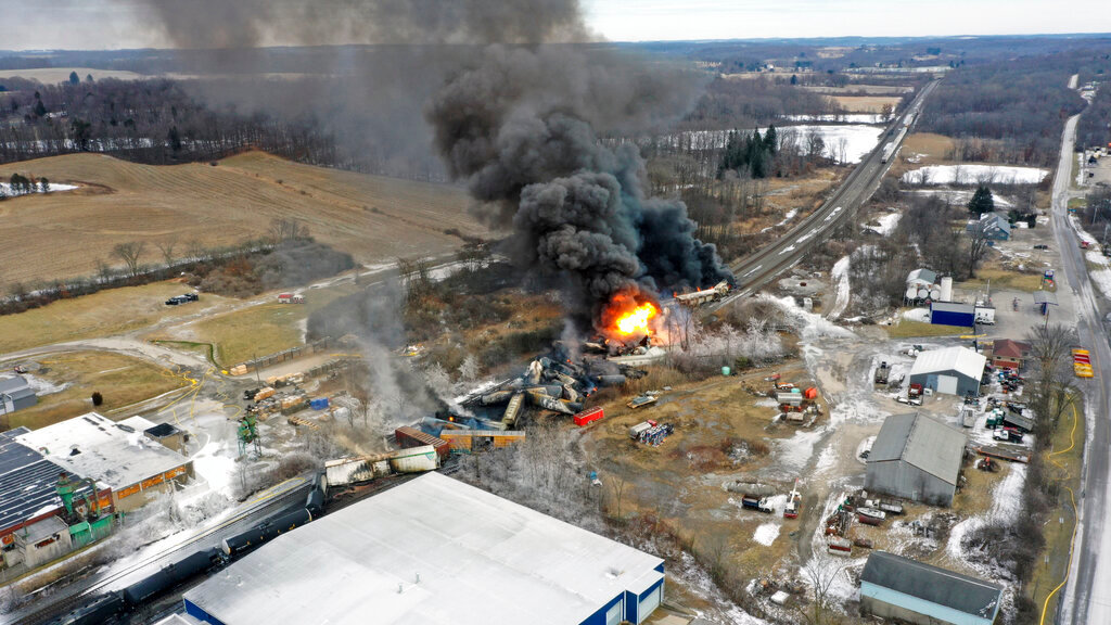 This photo taken with a drone shows portions of a Norfolk and Southern freight train that derailed Friday night in East Palestine, Ohio, and were still on fire at mid-day Saturday, Feb. 4, 2023. (AP Photo/Gene J. Puskar)