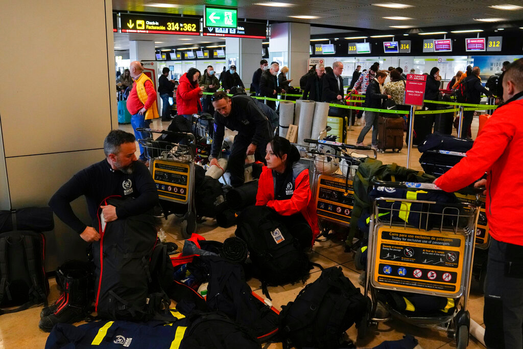 Spanish firefighters with their equipment at Barajas international airport, in Madrid, Spain, Monday, Feb. 6, 2023, before boarding a flight to help with a rescue mission in Turkey. (AP Photo/Paul White)