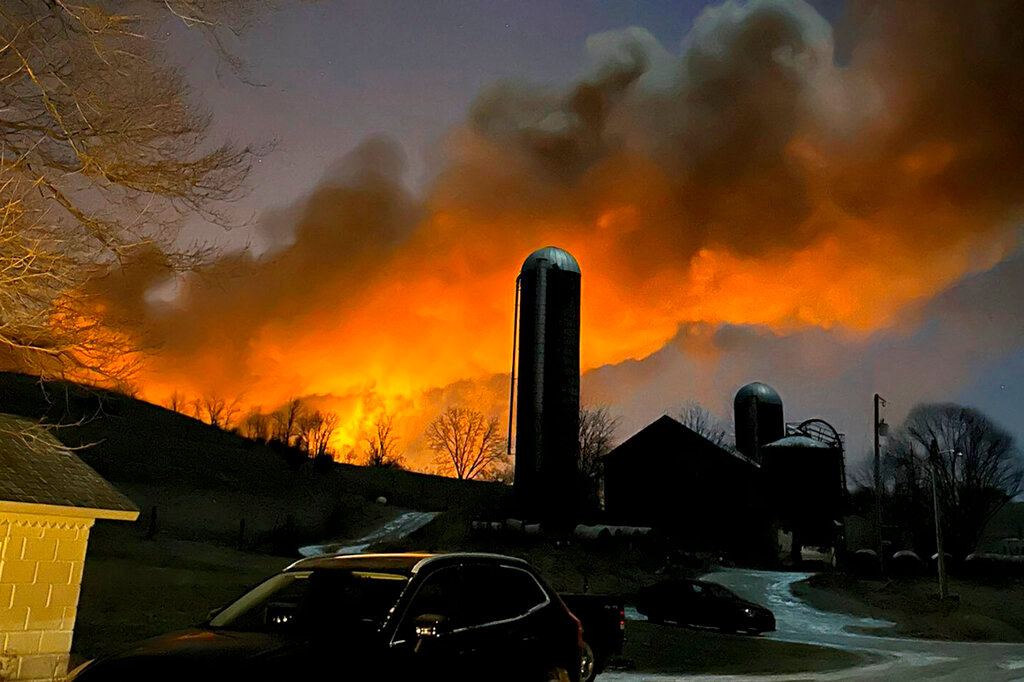 A train fire is seen from Melissa Smith's farm in East Palestine, Ohio, Friday, Feb. 3, 2023. (Melissa Smith via AP)
