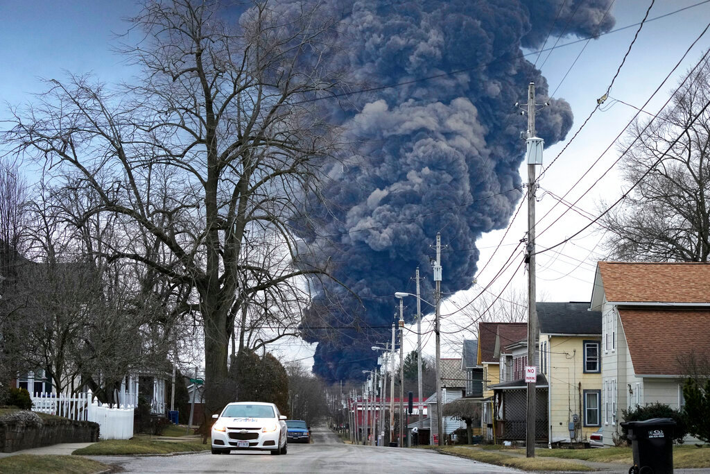 A black plume rises over East Palestine, Ohio, as a result of a controlled burn of toxic chemicals from a derailed Norfolk and Southern train Monday, Feb. 6, 2023. (AP Photo/Gene J. Puskar)