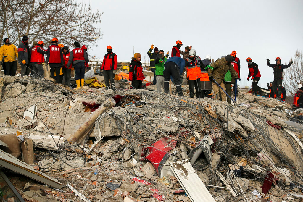 Rescue workers search for survivors in a collapsed building in Malatya, eastern Turkey, Wednesday, Feb. 8, 2023. (AP Photo/Emrah Gurel)