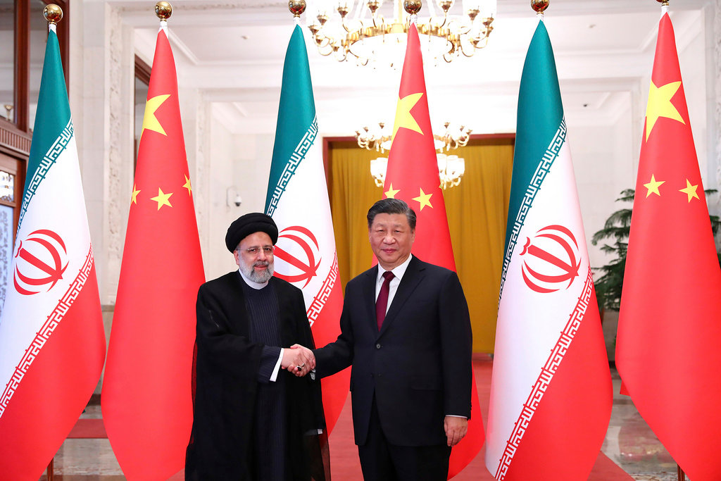 In this photo released by the official website of the office of the Iranian Presidency, President Ebrahim Raisi, left, shakes hands with his Chinese counterpart Xi Jinping in an official welcoming ceremony in Beijing, Feb. 14, 2023. (Iranian Presidency Office via AP, File)