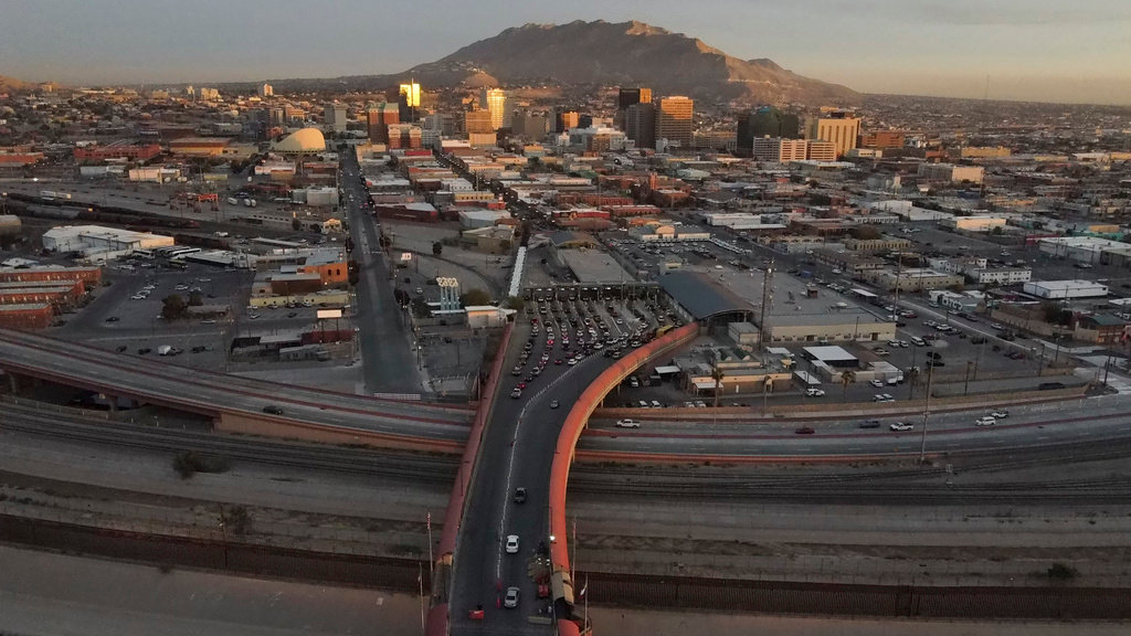 Cars line up at the Paso del Norte international bridge in Ciudad Juarez, Mexico, below, on the border with El Paso, Texas, top, Nov. 8, 2021. (AP Photo/Christian Chavez, file)