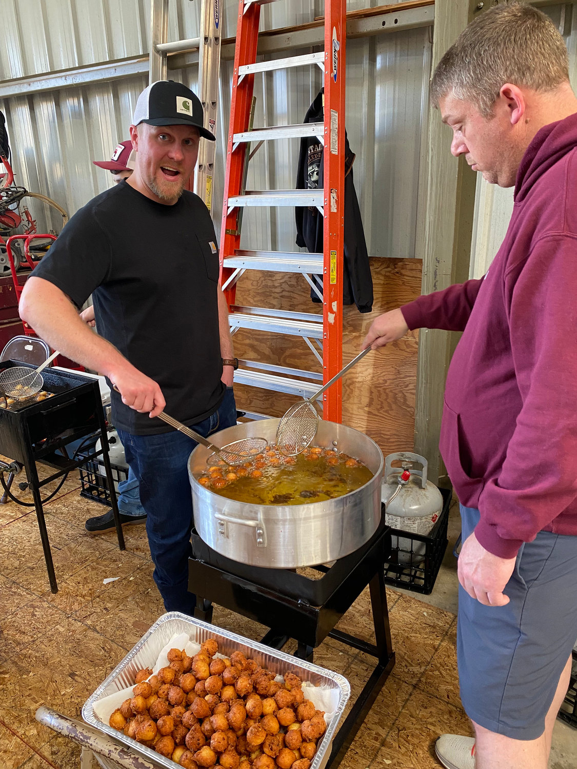 Josh Messer, left, and Josh Hawkesworth making hushpuppies by the thousands for the low-country boil.