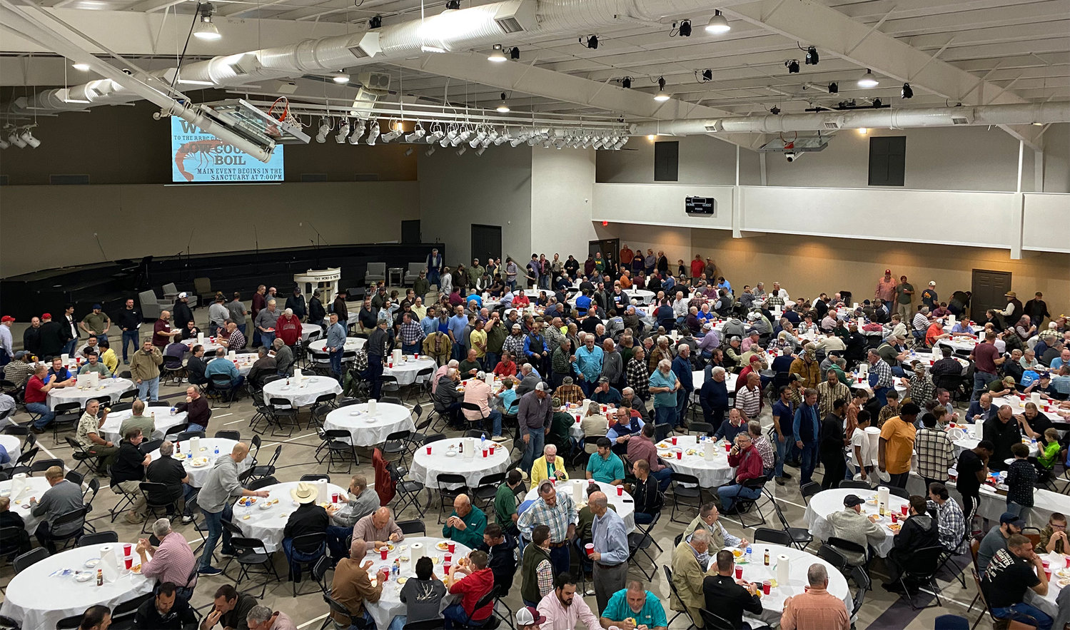 Hundreds of men gather in the Roopville Road Baptist Church Family Life Center recently for a low-country boil.