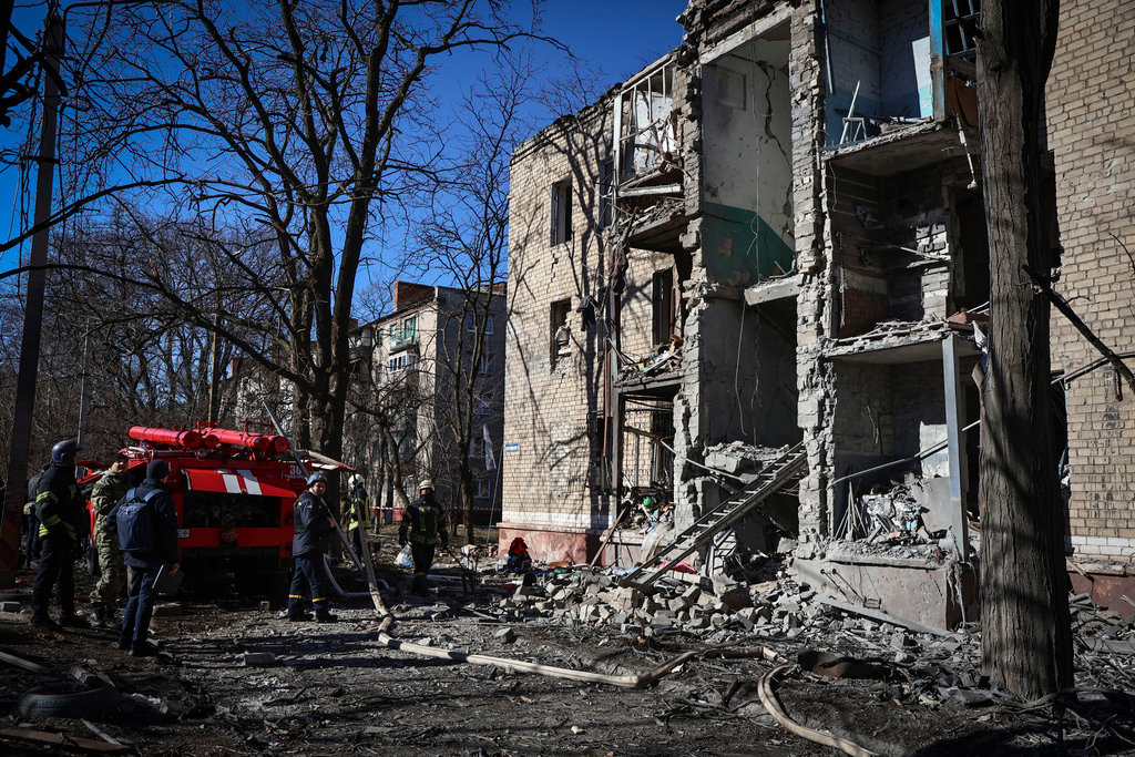 Ukrainian Emergency Service personnel respond to a building damaged by shelling in Kramatorsk, Donetsk region, Ukraine, Tuesday, March 14, 2023. (AP Photo/Roman Chop)