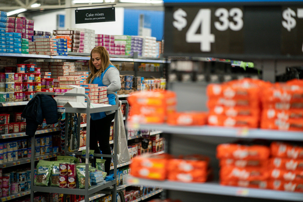 A worker organizes items at a Walmart Supercenter in North Bergen, N.J., on Feb. 9, 2023. (AP Photo/Eduardo Munoz Alvarez)