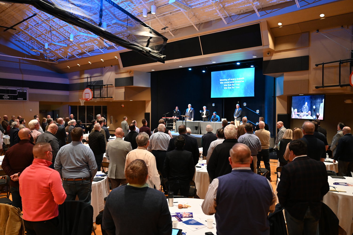Members of the Executive Committee open Tuesday's meeting by singing praises to the Lord. (Index/Roger Alford)