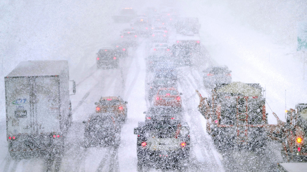 Plows, at right, try to pass nearly stopped traffic, due to weather conditions, on Route 93 South, Tuesday, March 14, 2023, in Londonderry, N.H. (AP Photo/Charles Krupa)