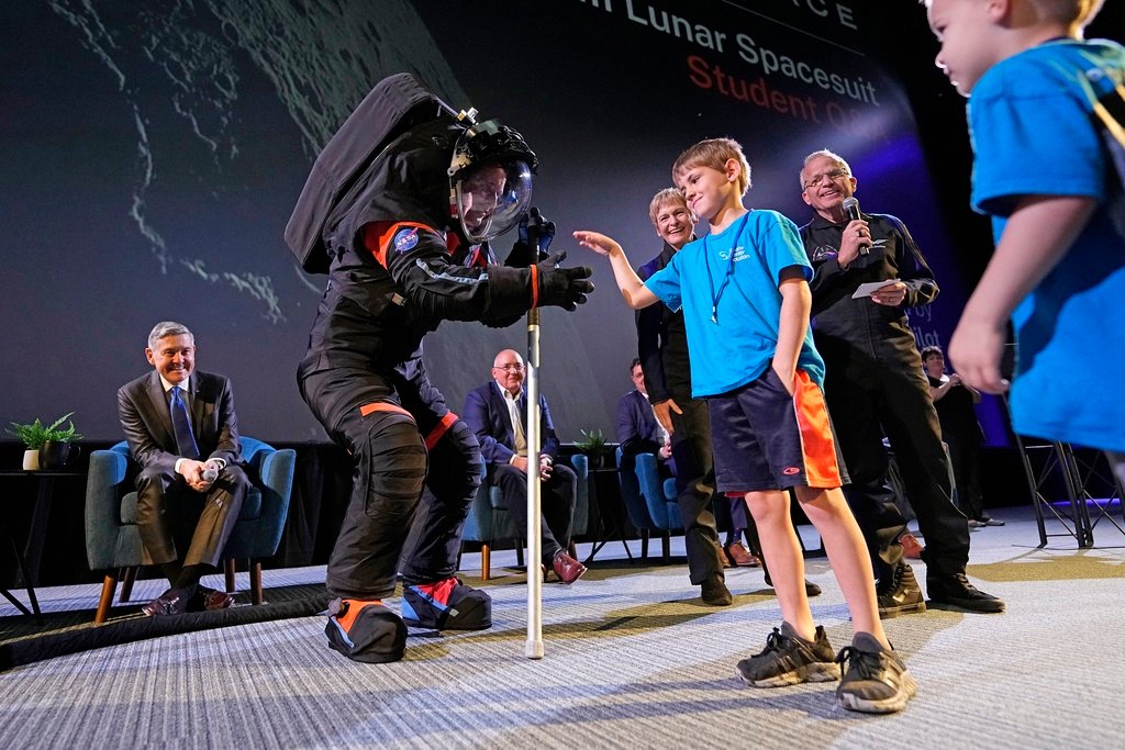 Axiom Space chief engineer Jim Stein, left, greets children during a demonstration Wednesday, March 15, 2023, in Houston. (AP Photo/David J. Phillip)