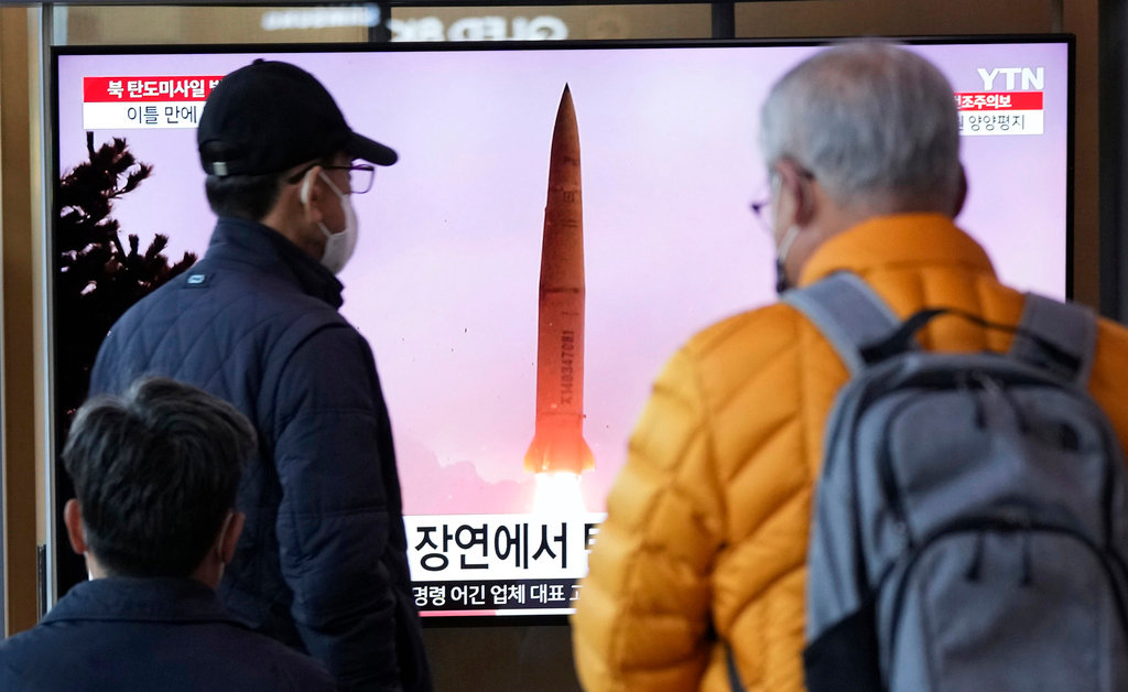 A TV screen shows a file image of a North Korean missile launch during a news program at the Seoul Railway Station in Seoul, South Korea, Thursday, March 16, 2023. (AP Photo/Ahn Young-joon)