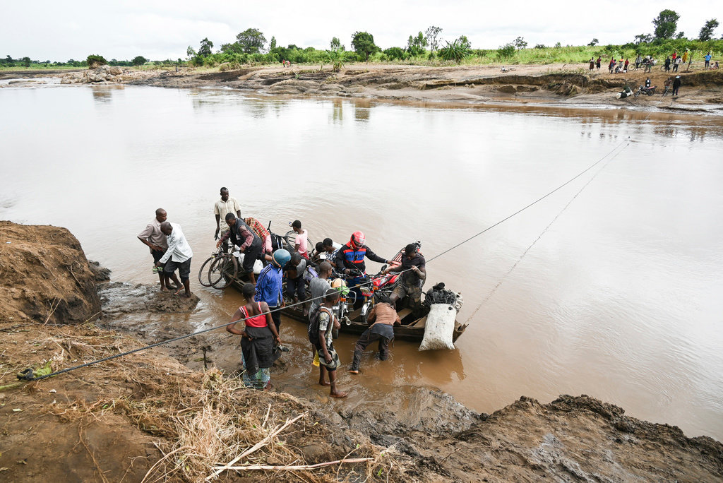 Men transport their salvaged belongings in Chiradzulu, southern Malawi, Friday March 17, 2023. (AP Photo/Thoko Chikondi)