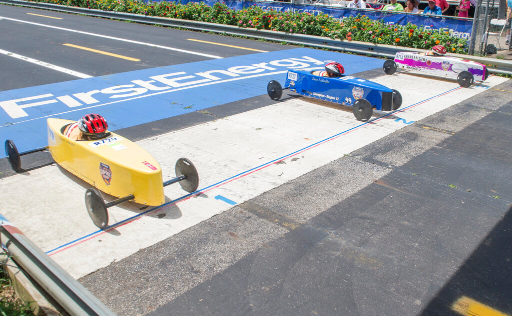 Alexa Garren (713) of Villa Rica, Ga. noses out Lane Schlafke (727) of Glasgow, Ky. and Kierra Johnson (729) of Owensboro, Ky. during their Rally Stock heat at the First Energy All-American Soap Box Derby, in Akron, Ohio, July 20, 2019. (AP Photo/Phil Long, File)