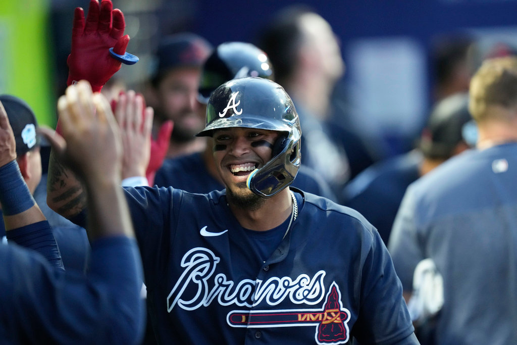 Atlanta Braves Orlando Arcia is greeted in the dugout after a two-run homer in against the Philadelphia Phillies in North Port, Fla., Saturday, March 18, 2023. (AP Photo/Gerald Herbert)