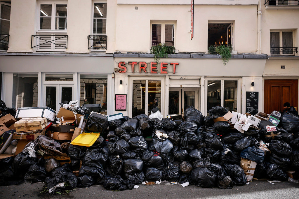 Uncollected garbage is piled up on a street in Paris, March 15, 2023, during an ongoing strike by sanitation workers. (AP Photo/Thomas Padilla)