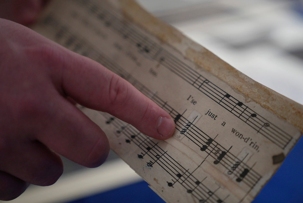 Christopher Lynch, music historian with the Center for American Music at the University of Pittsburgh, holds a piece of sheet music written by Charles Henry Pace, on Tuesday, Feb. 28, 2023, at the University of Pittsburgh, in Pittsburgh. (AP Photo/Jessie Wardarski)
