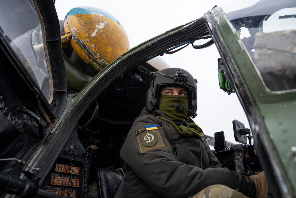 A Ukrainian pilot prepares for a flight on his Mi-24 attack helicopter during during a combat mission in Donetsk region, Ukraine, Saturday, March 18, 2023. (AP Photo/Evgeniy Maloletka)