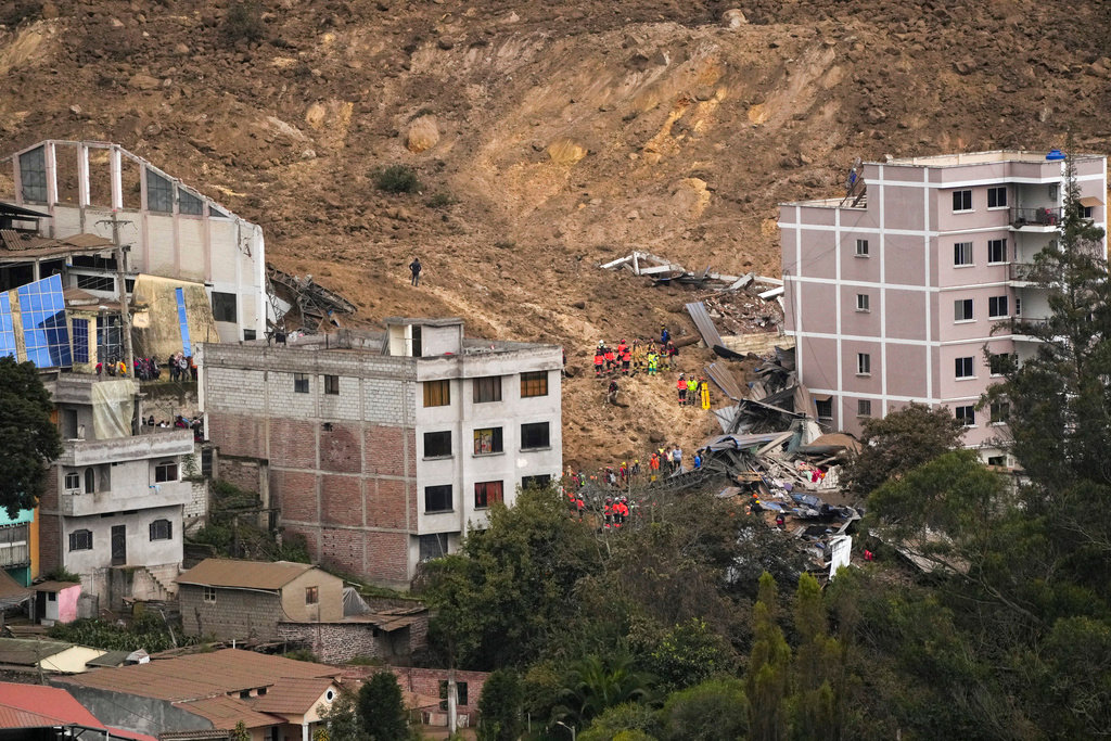 Rescue work is carried out at the site of a landslide that buried dozens of homes in Alausi, Ecuador, Monday, March 27, 2023. (AP Photo/Dolores Ochoa)