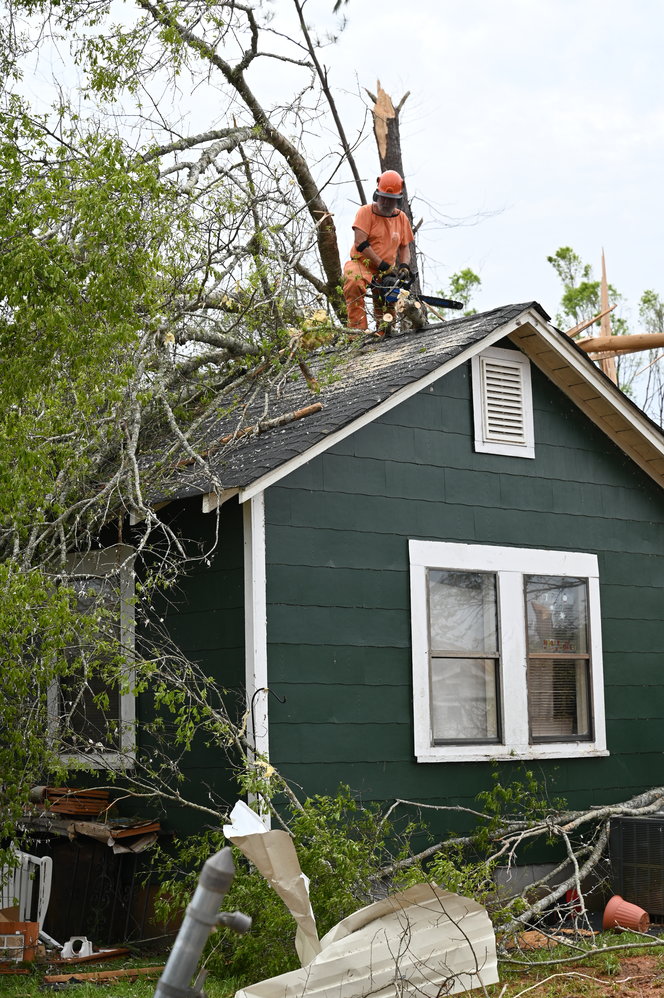 Crews work to remove a fallen tree from a home in West Point, Ga., on Tuesday, March 28, 2023. (Index/Roger Alford)