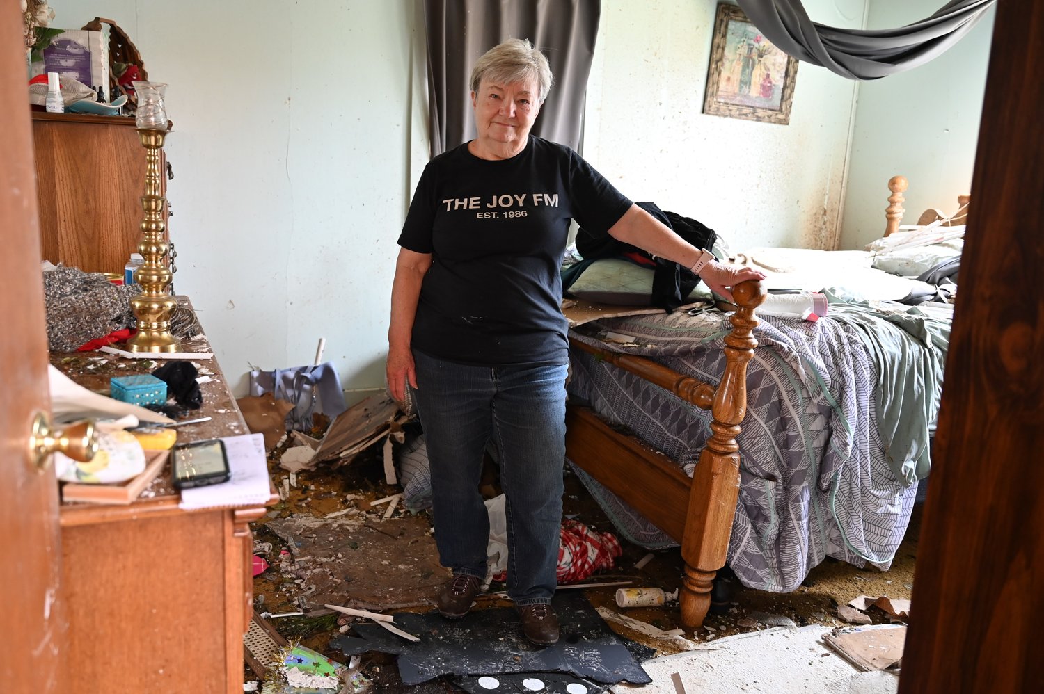 Sherry Bennett stands in her home in West Point, Ga., where she survived a violent tornado on Sunday. The twister ripped her roof off, blew away her garage, and devastated her community. (Index/Roger Alford)