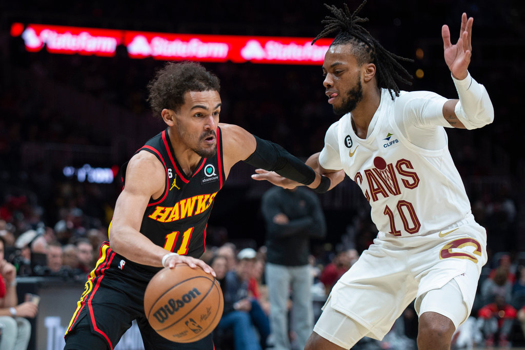 Atlanta Hawks guard Trae Young drives against Cleveland Cavaliers guard Darius Garland during the first half Tuesday, March 28, 2023, in Atlanta. (AP Photo/Hakim Wright Sr.)