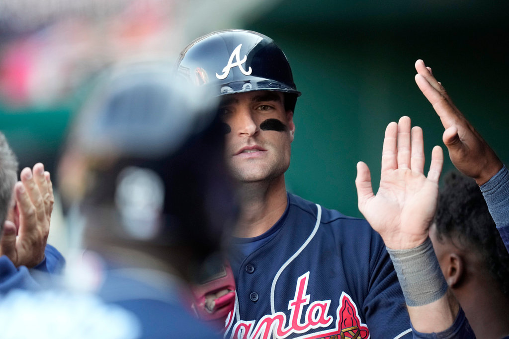 Atlanta Braves' Sam Hilliard high-fives teammates in the dugout after scoring on Travis d'Arnaud's double during the ninth inning against the Washington Nationals, Thursday, March 30, 2023, in Washington. (AP Photo/Alex Brandon)