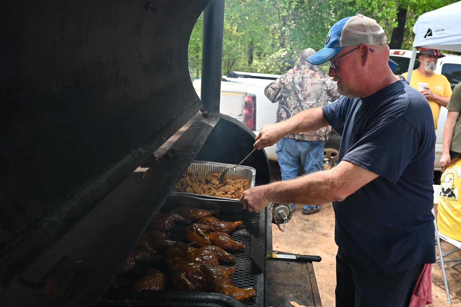 New Bethel Baptist Church Pastor Danny Craft prepares chicken for the Christian barbecue competition in Preston, Ga. on Saturday, April 1, 2023. (Index/Roger Alford)