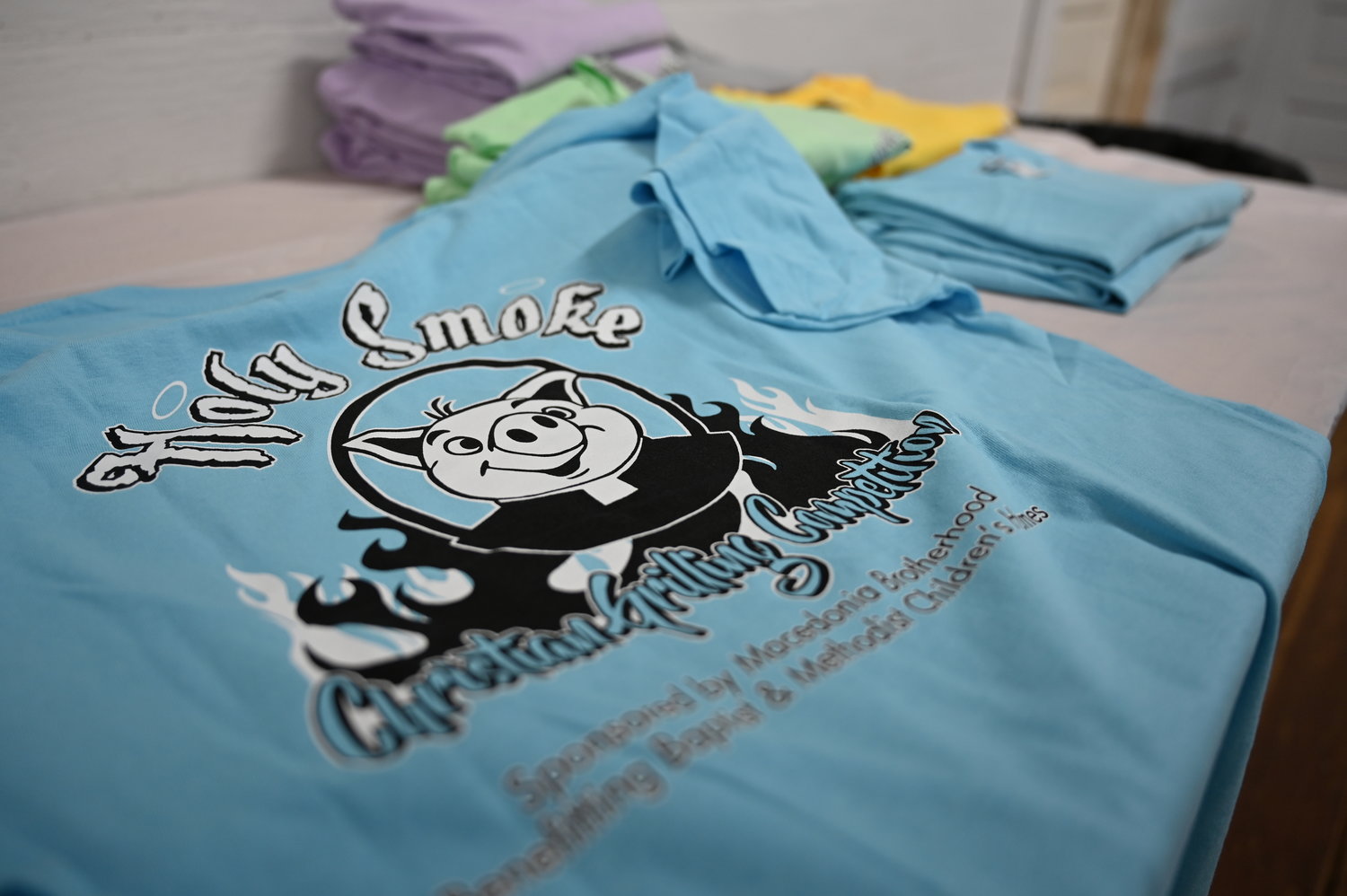 T-shirts promote one of southwest Georgia's favorite event, the Holy Smoke Christian Barbecue Competition. (Index/Roger Alford)