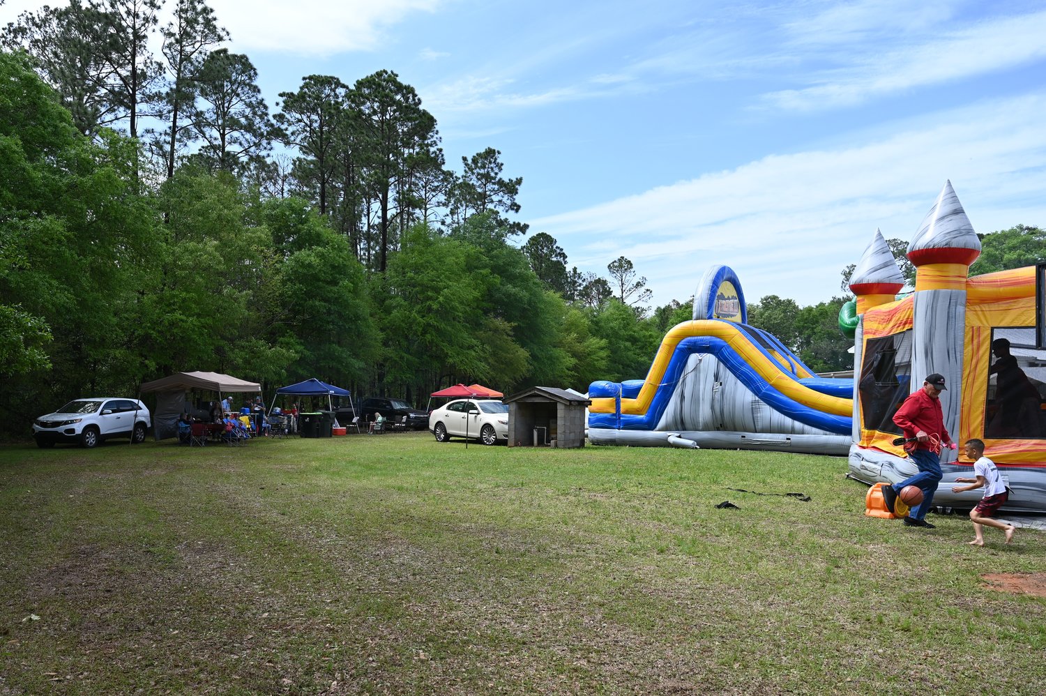 Inflatables keep kids busy while parents cook and eat at the Holy Smoke Christian Barbecue Competition in Preston, Ga. on Saturday, April 1, 2023. (Index/Roger Alford)