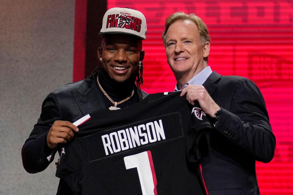 Texas running back Bijan Robinson, left, poses with NFL Commissioner Roger Goodell after being chosen by the Atlanta Falcons with the eighth overall pick during the first round of the draft Thursday, April 27, 2023, in Kansas City, Mo. (AP Photo/Jeff Roberson)