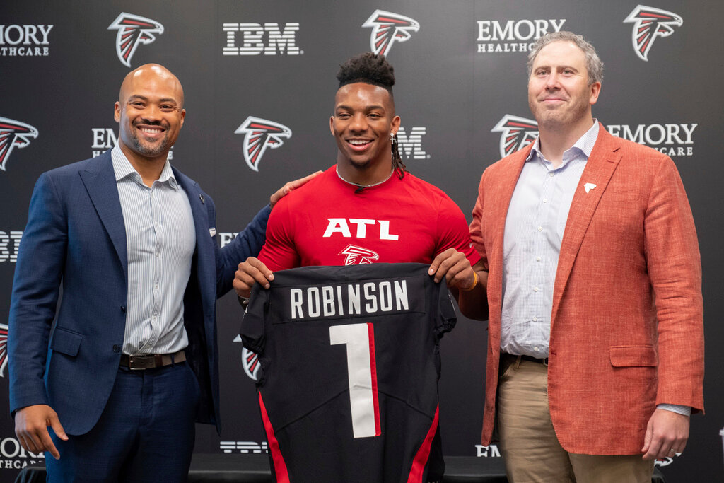 Atlanta Falcons General Manager Terry Fontenot, from left, first round draft pick Bijan Robinson and head coach Arthur Smith pose in Flowery Branch, Ga., on Friday, April 28, 2023. (AP Photo/Ben Gray)