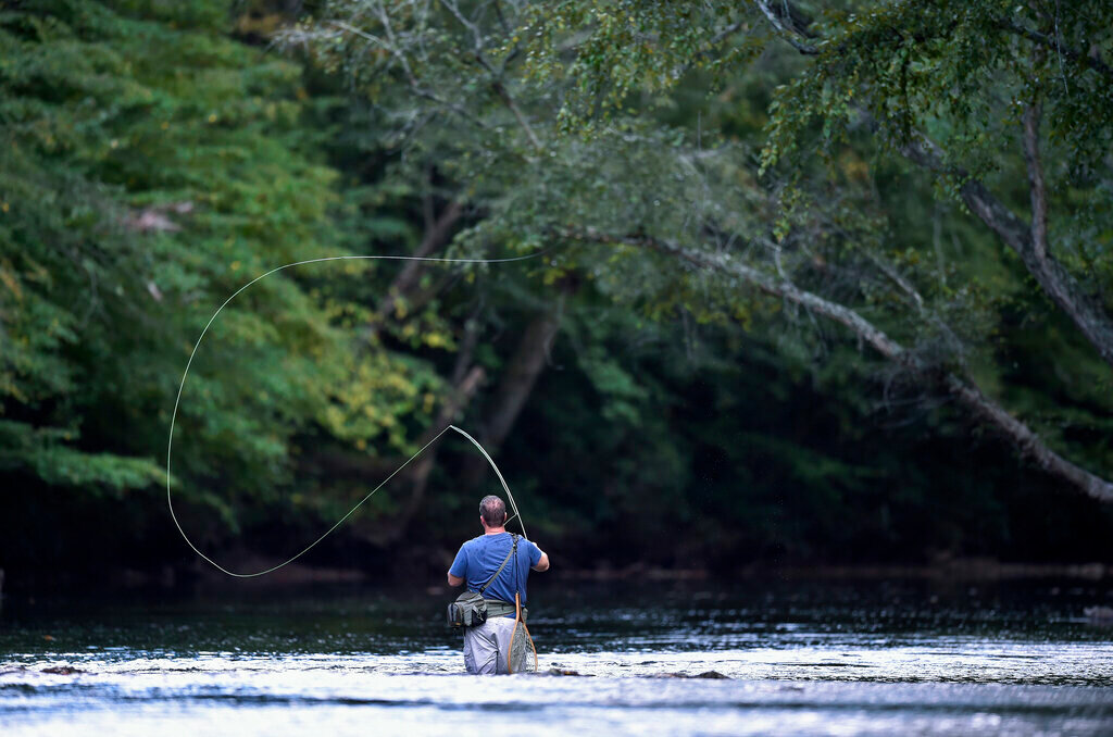 Pastor Kevin Magnum fly fishes on the Chattahoochee River, Friday, Sept. 23, 2016, near Demorest, Ga. (AP Photo/Mike Stewart, File)