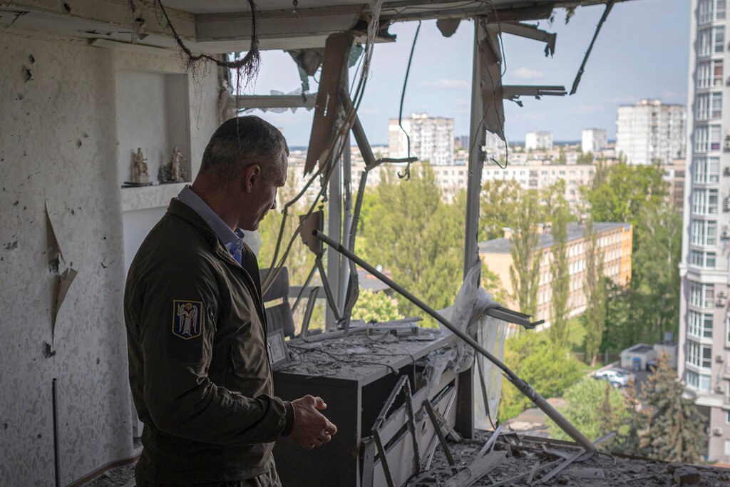 Kyiv Mayor Vitali Klitschko stands in an apartment building damaged by a drone that was shot down during a Russian overnight strike in Kyiv, Ukraine, Monday, May 8, 2023. (AP Photo/Andrew Kravchenko)