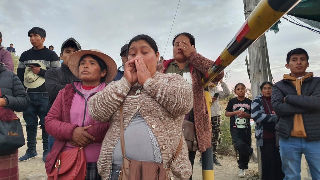 Relatives of trapped miners wait outside the SERMIGOLD mine in Arequipa, Peru, Sunday, May 7, 2023. (AP Photo/Fernando Mojito)