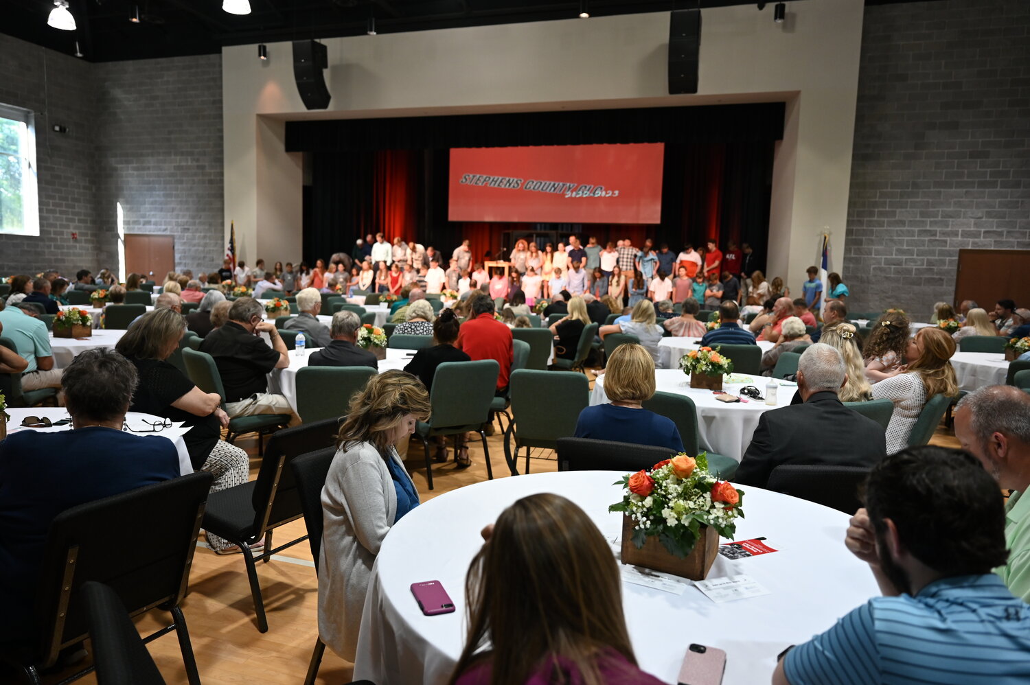 A room filled with family members and supporters pray for kids who took Bible classes at the Christian learning center in Stephens County on Sunday, May 21, 2023.