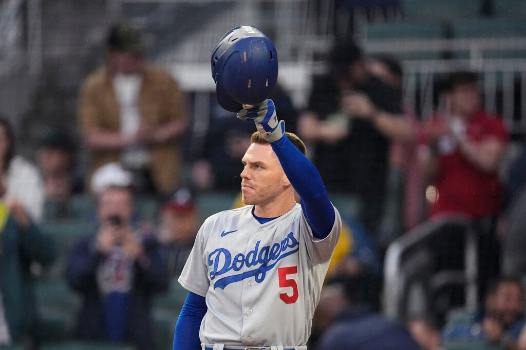 Los Angeles Dodgers first baseman and former Atlanta Brave Freddie Freeman tips his helmet to the crowd as he steps to the plate to bat in the first inning against the Atlanta Braves, Monday, May 22, 2023, in Atlanta. (AP Photo/John Bazemore)