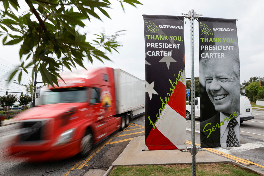 Motorists pass a sign honoring former President Jimmy Carter along Jimmy Carter Blvd. on Tuesday, May 23, 2023, in Norcross, Ga. (AP Photo/Alex Slitz)