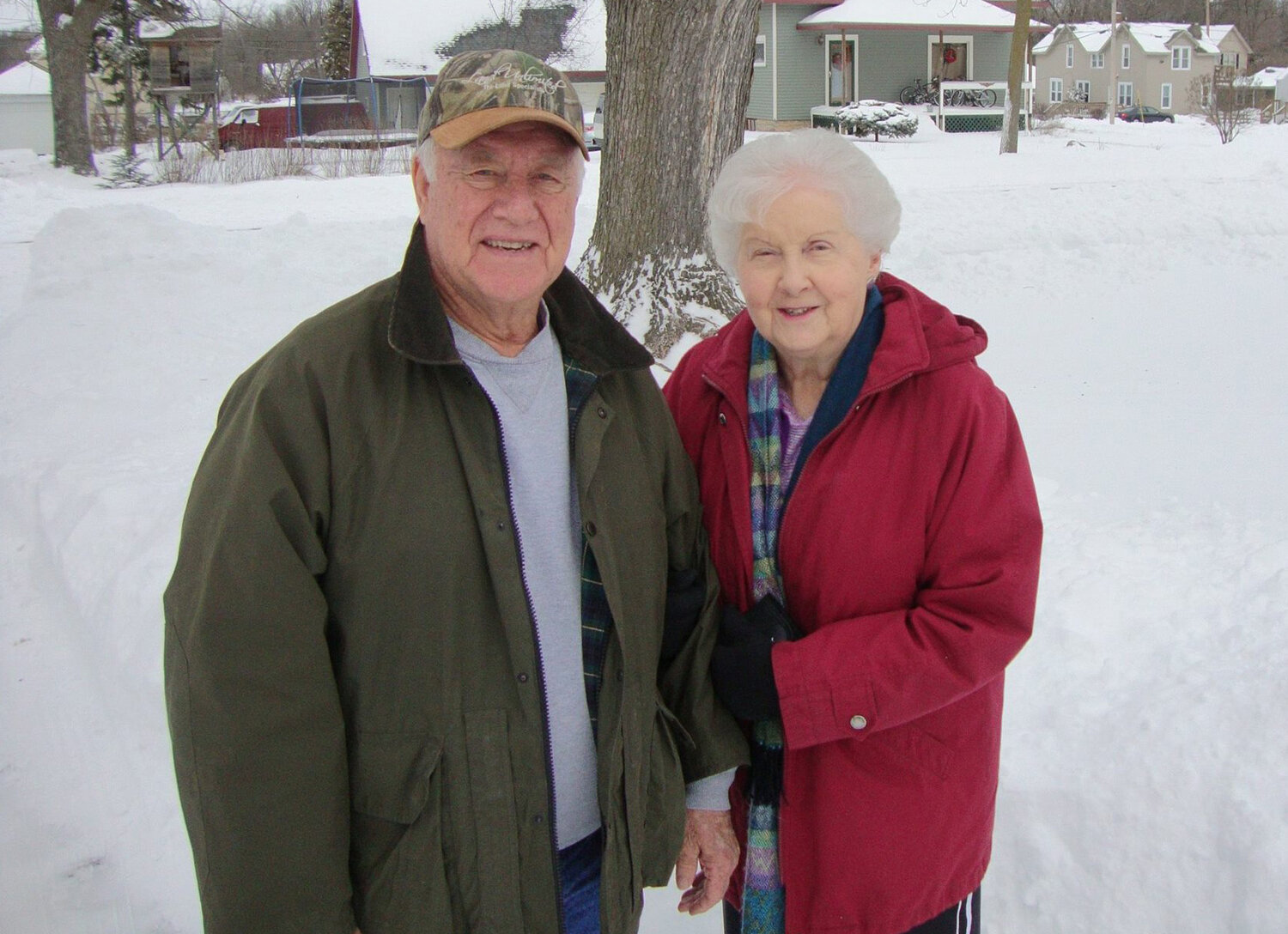 Ken and Mary Ellison stand in the snow in front of their daughter’s house in Wisconsin.