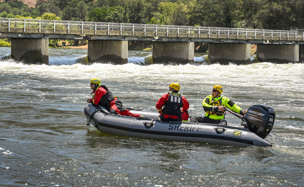 Fresno County Sheriff's Office search and rescue team members return upriver to a boat launch near the Pine Flat Dam near Sanger, Calif., after reports that a boy's body had been recovered on the Kings River, May 22, 2023. (Craig Kohlruss/The Fresno Bee via AP)