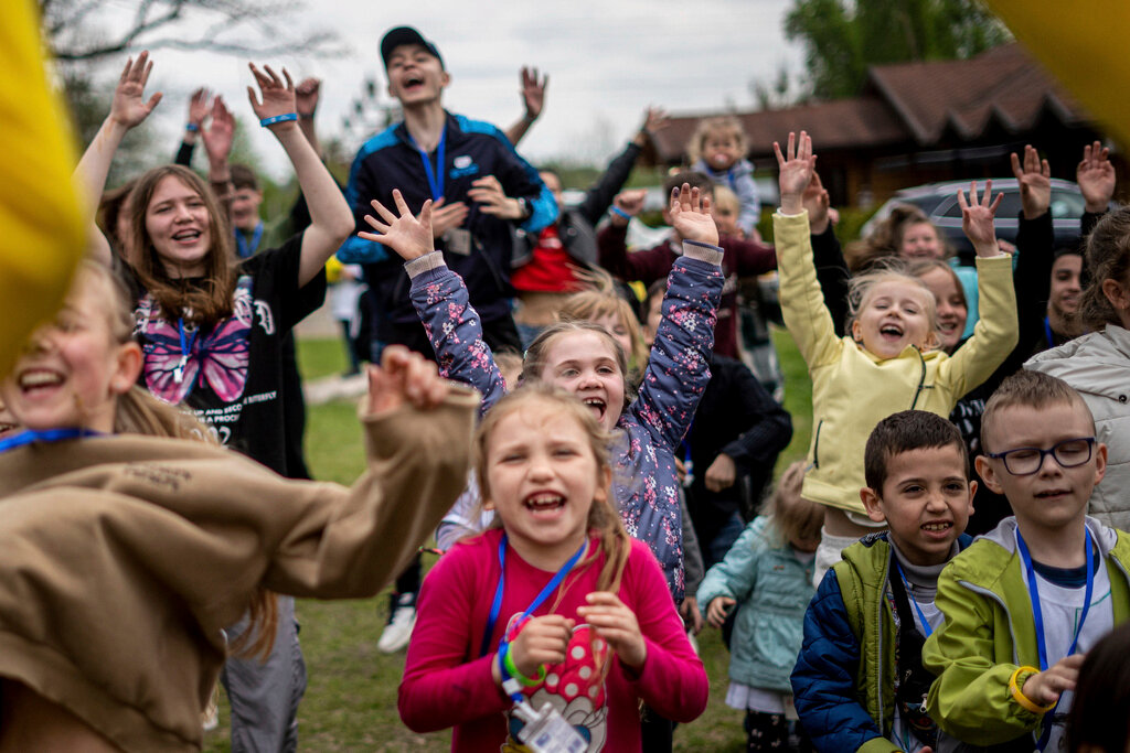 Children dance at the recovery camp for children and their mothers affected by the war near Lviv, Ukraine, Wednesday, May 3, 2023. (AP Photo/Hanna Arhirova)