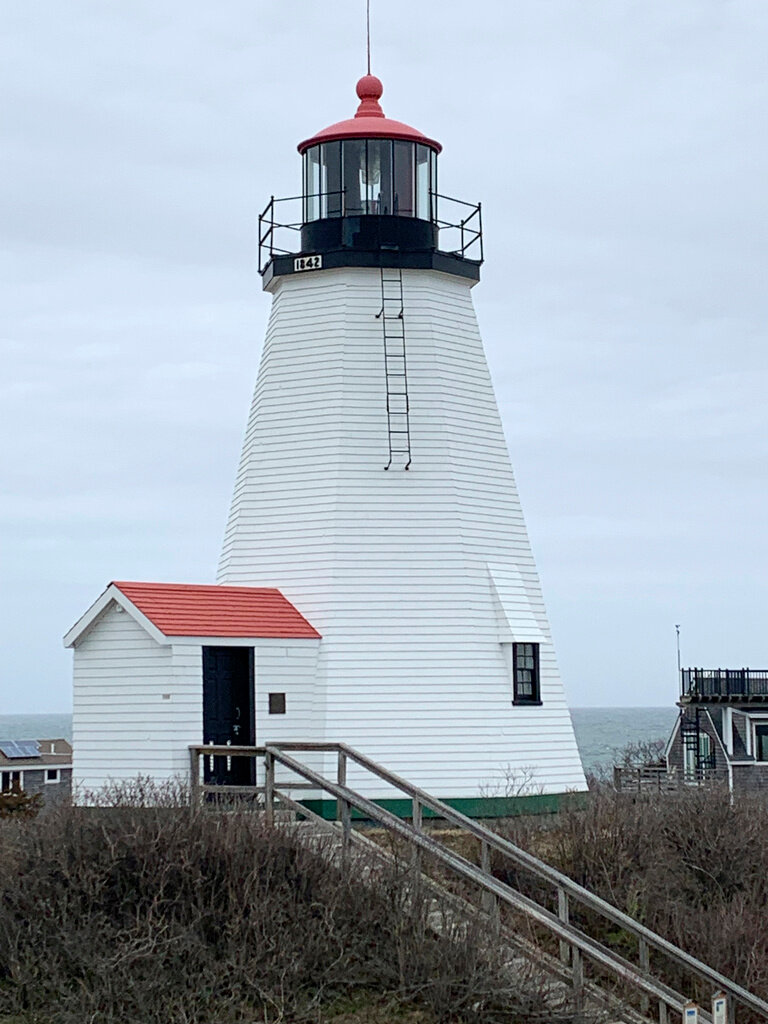 Plymouth Light Station, with an octagonal wooden structure dates to 1842, stands near Cape Cod Bay and Plymouth Bay, April 5, 2023, in Plymouth, Mass. (Paul Hughes/General Services Administration via AP)