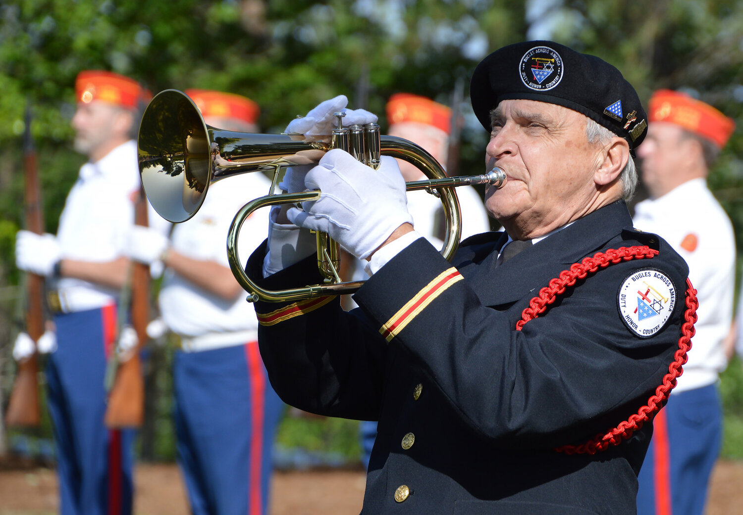 Bill Hall, state director of Bugles Across America, plays "Taps" during a ceremony at the Georgia National Cemetery in Canton, Ga., Saturday, May 27, 2023. (Index/Henry Durand)