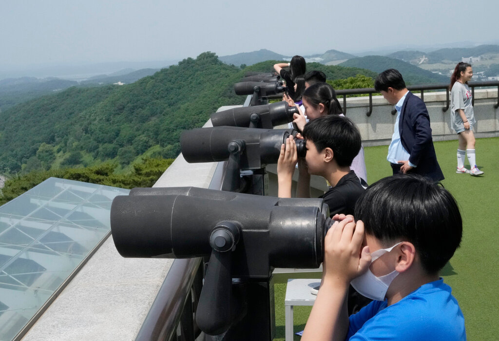Elementary school students look at North Korea side from the Unification Observation Post in Paju, South Korea, near the border with North Korea, Wednesday, May 31, 2023. (AP Photo/Ahn Young-joon)
