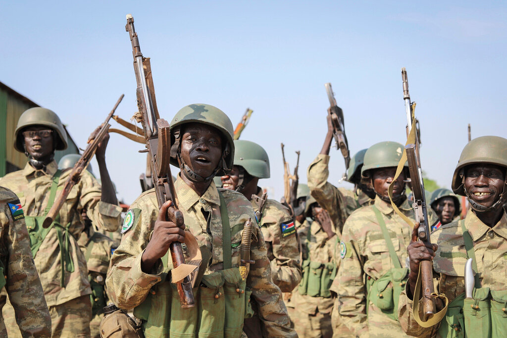 Soldiers from the South Sudan People's Defence Forces prepare to board a flight at the airport in Juba, South Sudan, April 3, 2023. (AP Photo/Samir Bol, File)