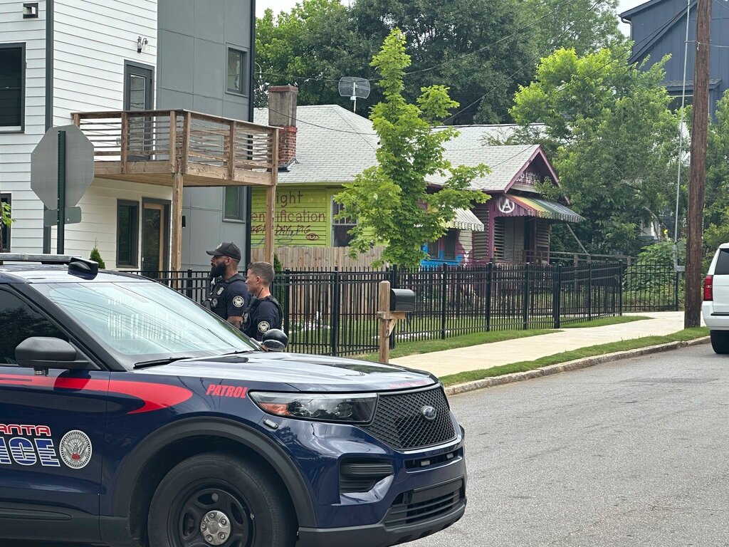 Police block traffic on the block of a house in the Edgewood neighborhood where three key organizers who have been aiding protesters against the city's proposed public safety training center were arrested on Wednesday, May 31, 2023, in Atlanta. (AP Photo/Kate Brumback)