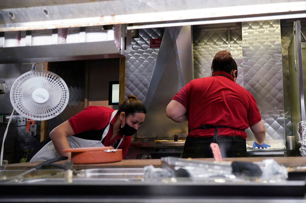 Women work in a restaurant kitchen in Chicago, Thursday, March 23, 2023. (AP Photo/Nam Y. Huh, File)