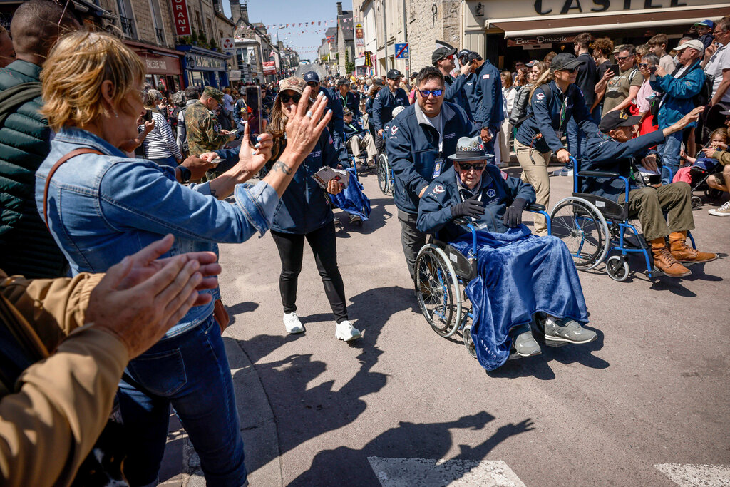 U.S. veterans parade during a gathering in preparation of the 79th D-Day anniversary in Sainte-Mere-Eglise, Normandy, France, Sunday, June 4, 2023. (AP Photo/Thomas Padilla)